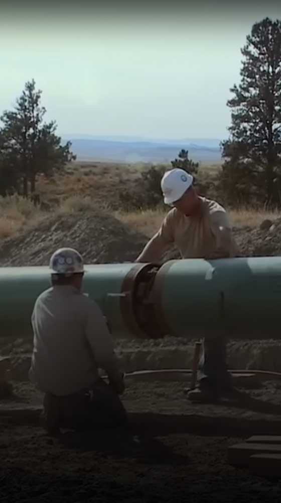 two men weld a pipline for CO2